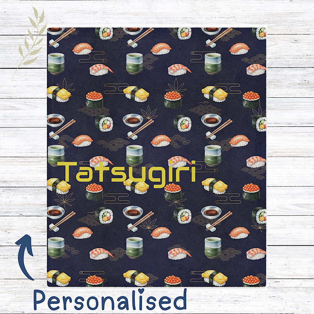 Sushi Patterned throw blanket with custom name on a wooden surface