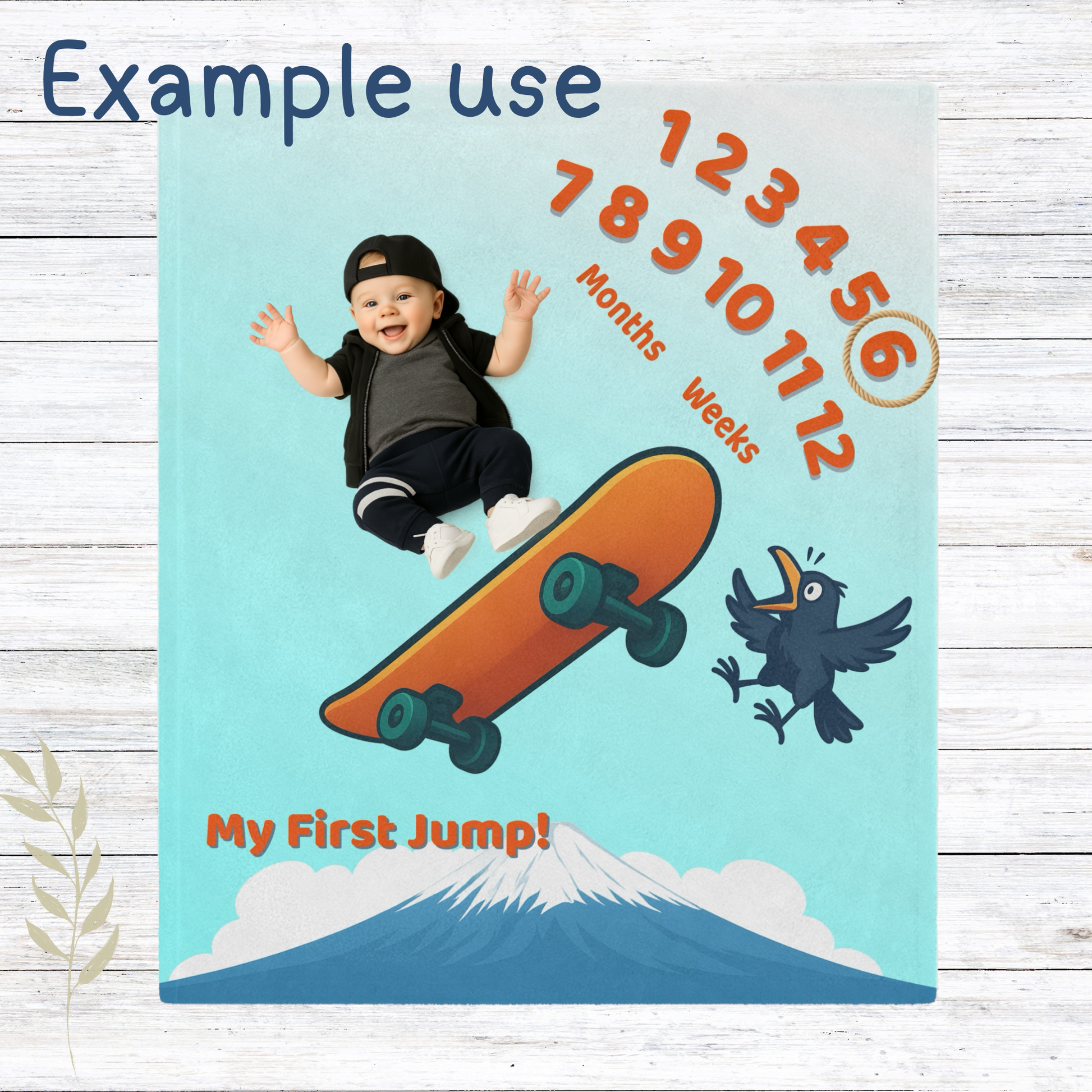 “Skateboard-themed baby milestone blanket with bright orange board, excited cartoon bird, Mt. Fuji in the background, and ‘My First Jump!’ text. Sherpa fleece backing, perfect for weekly or monthly baby photo sessions.”
