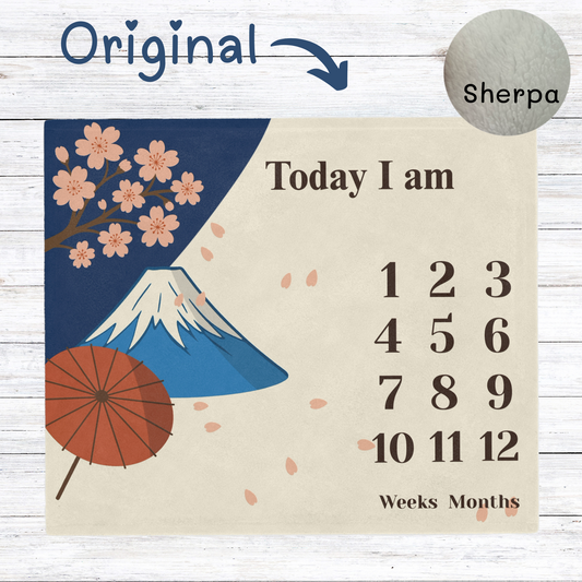 “Japanese-style baby milestone blanket with cherry blossoms, Mt. Fuji, and parasol design. Soft sherpa fleece, perfect for newborn photo props and monthly baby pictures.”