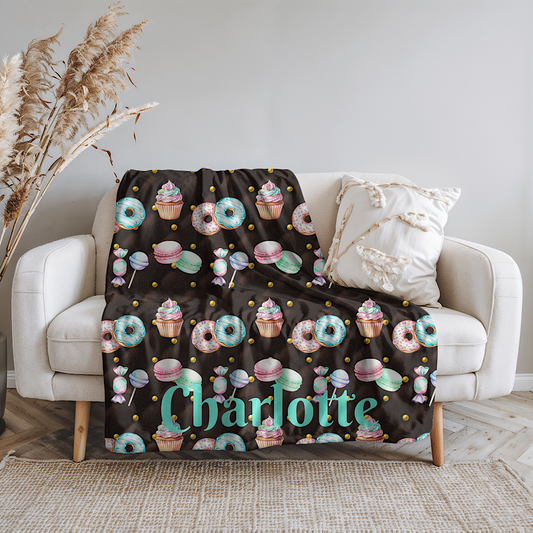 Chocolate colour throw Blanket with colorful dessert pattern on a white couch.