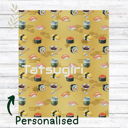 Personalised Sushi patterned gold colour throw blanket on a wooden surface