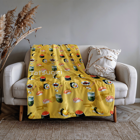 Gold Throw blanket with sushi pattern draped over a beige sofa in a living room.