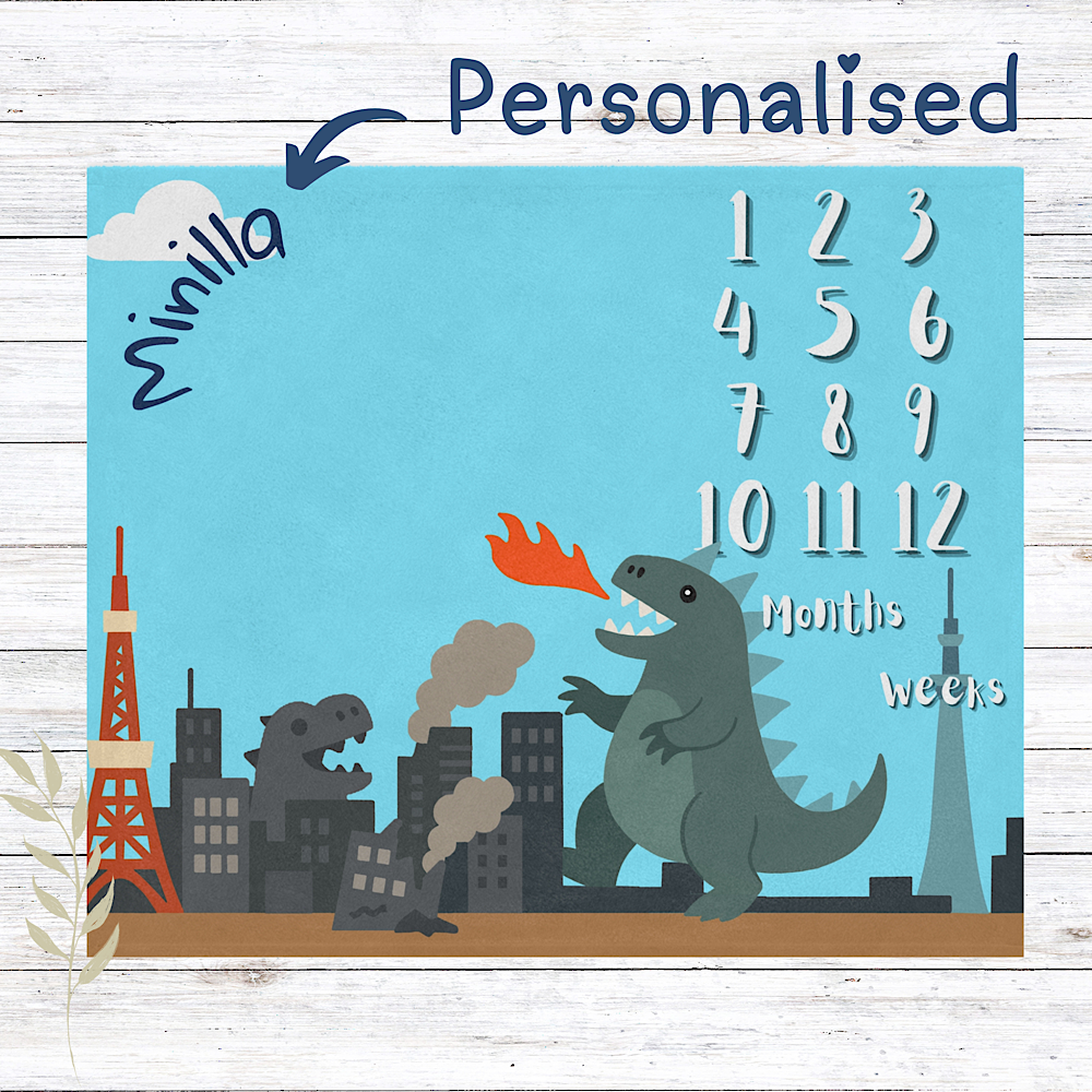 Personalised baby milestone chart with kaiju and cityscape design on a blue background.