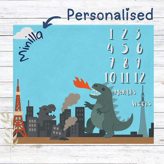 Personalised baby milestone chart with kaiju and cityscape design on a blue background.