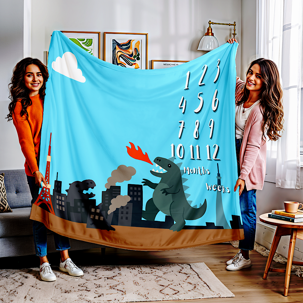 Two women holding blue personalised baby milestone blanket with a kaiju design in a living room.