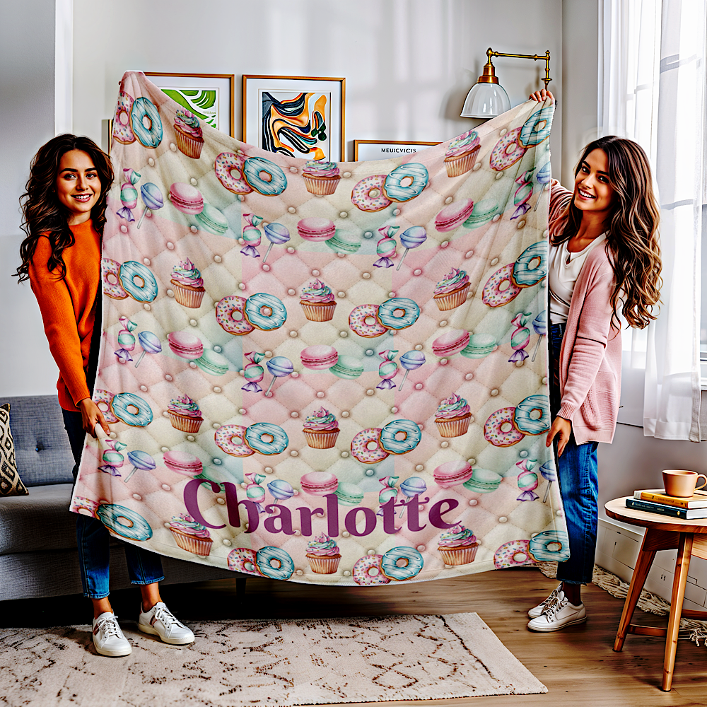 Two women holding a personalised pink throw blanket with in a living room.