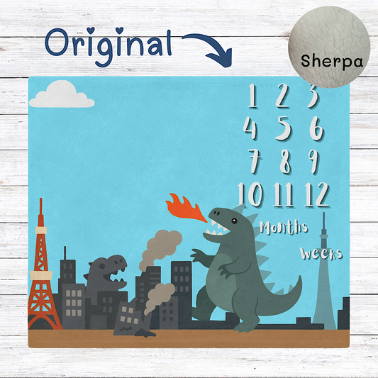 Baby milestone blanket with cartoon dinosaur and cityscape design