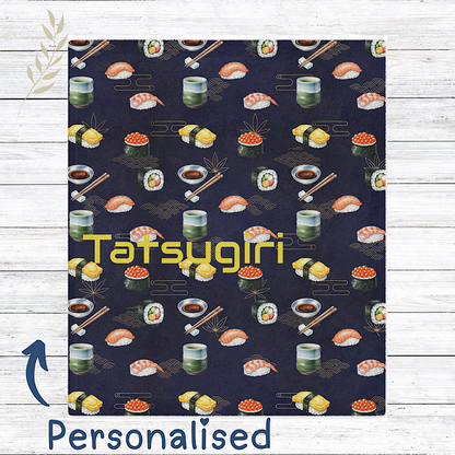 Sushi Patterned throw blanket with custom name on a wooden surface